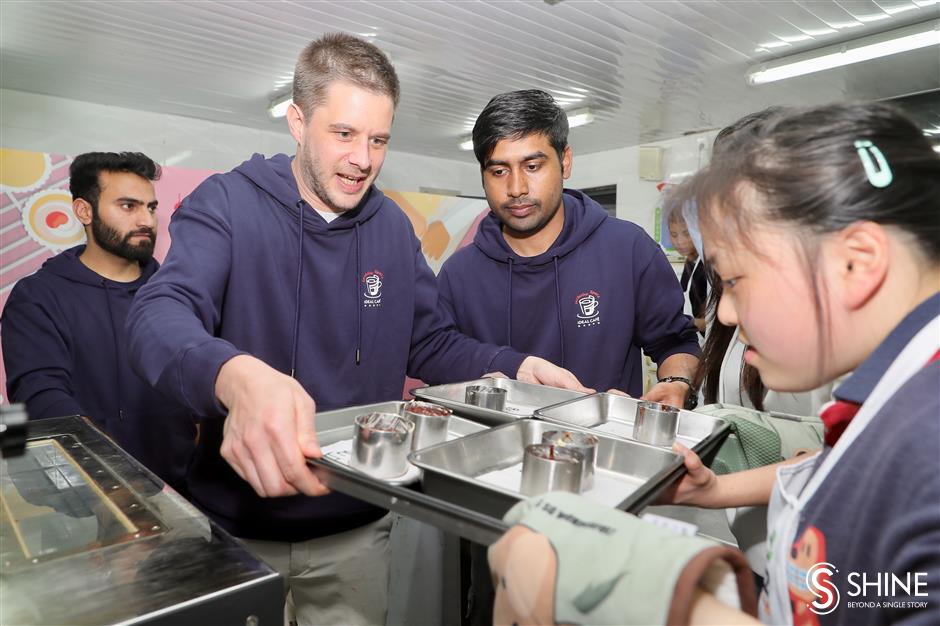 global volunteers come together to bake and learn with special needs students in shanghai