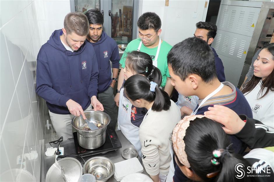 global volunteers come together to bake and learn with special needs students in shanghai