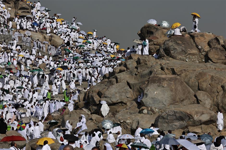 muslim pilgrims pray on mount arafat in hajj climax